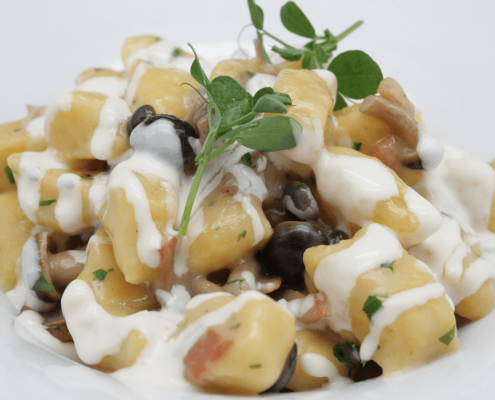 Gnocchi di zucca con pioppini, fonduta di Taleggio e pancetta